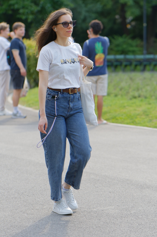 25 - Girl walking in a park, capturing a candid moment of someone in casual attire